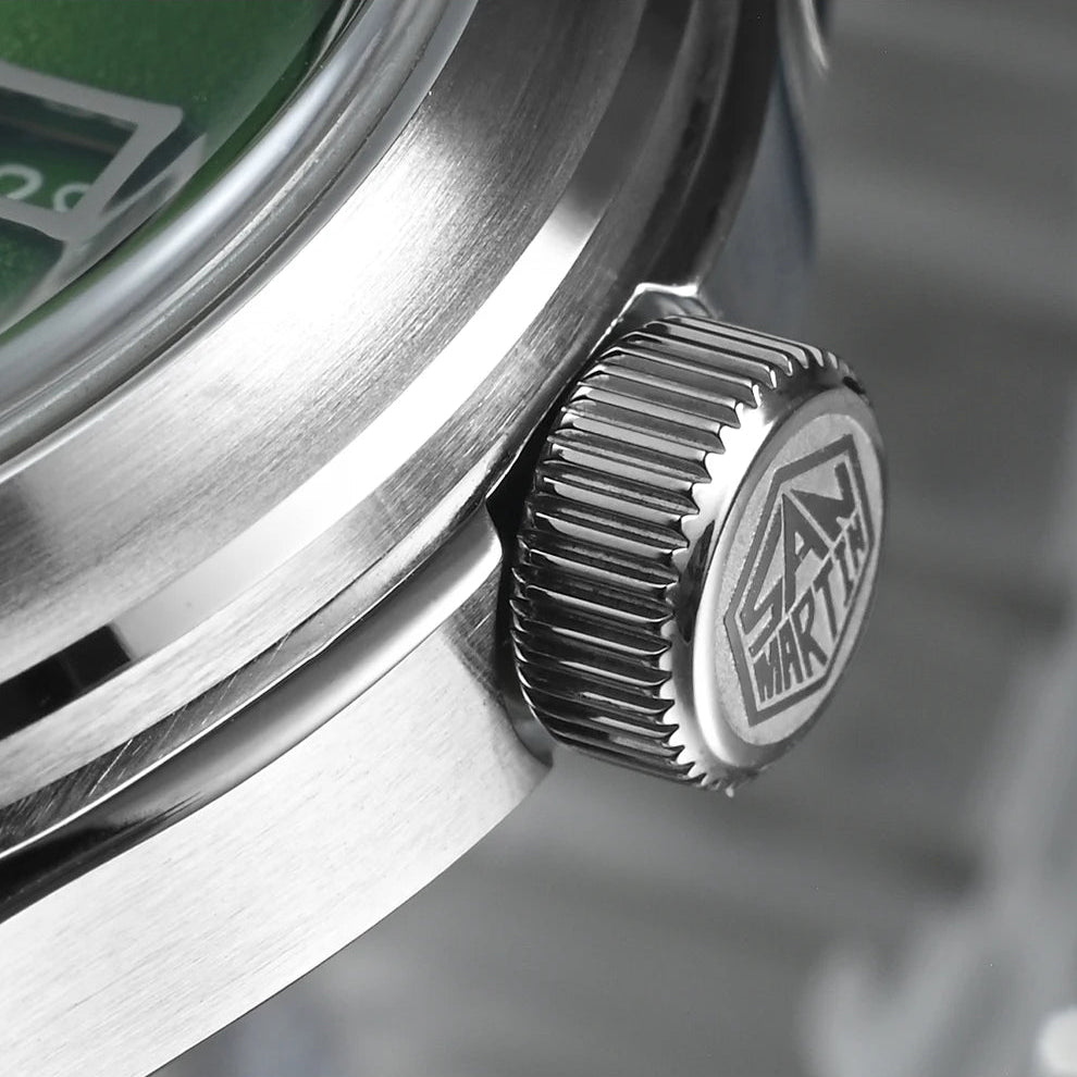 Close-up macro view of the San Martin SN0144-DG crown featuring engraved San Martin logo and brushed stainless steel case finish