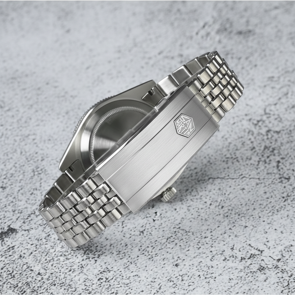 Silver watch with metal bracelet on a textured gray surface