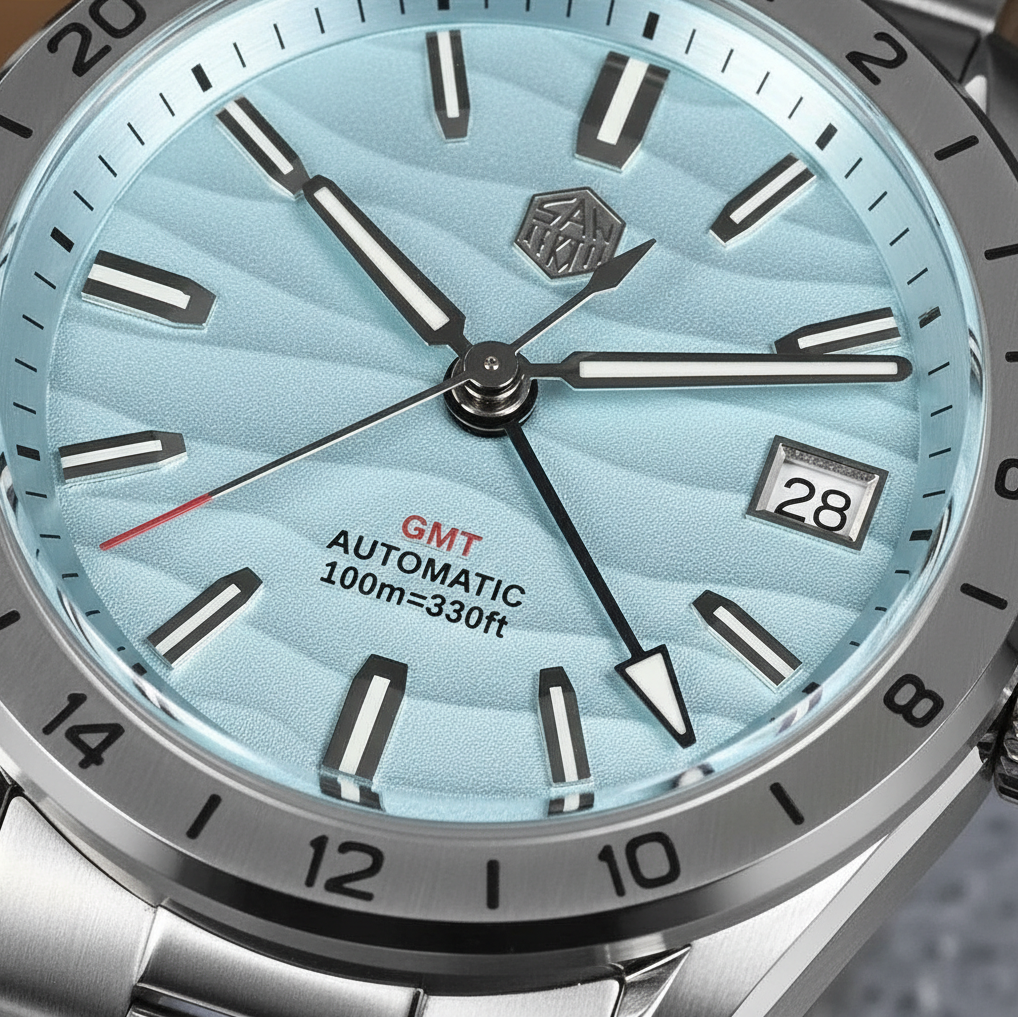 Watch face with blue gradient dial, silver bezel, and visible brand logo.