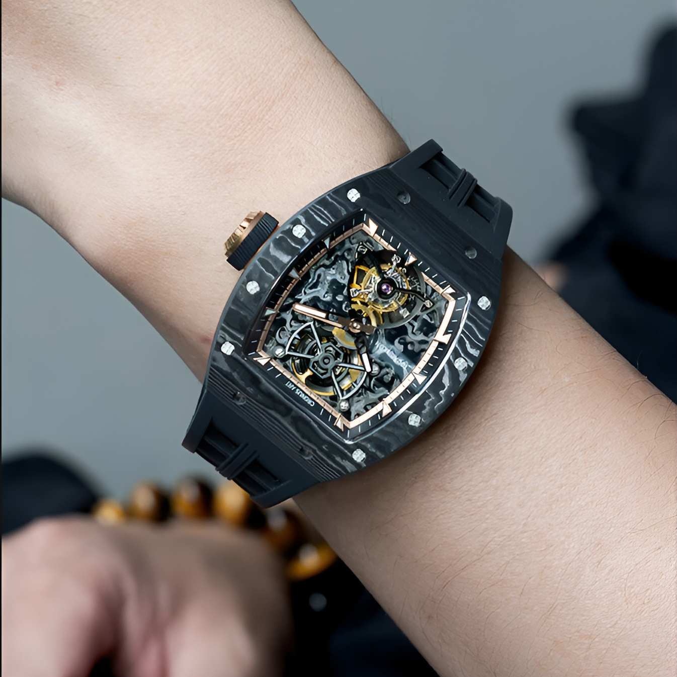 CRONUSART CM002-052 - Carbon fiber tourbillon watch with skeleton dial worn on wrist featuring black rubber strap and rose gold accents