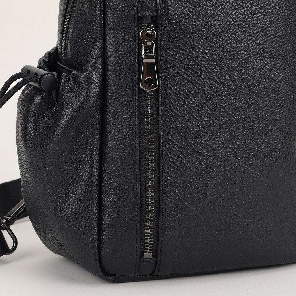 Men's Full-Grain Leather Sling Bag with Side Pockets — close-up of the front pocket and stitching