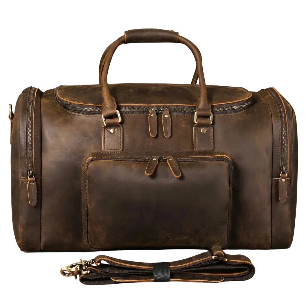 A dark brown distressed leather duffel bag with top handles, a front zippered pocket, and a detachable shoulder strap, displayed on a light cream background.