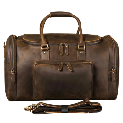 A dark brown distressed leather duffel bag with top handles, a front zippered pocket, and a detachable shoulder strap, displayed on a light cream background.
