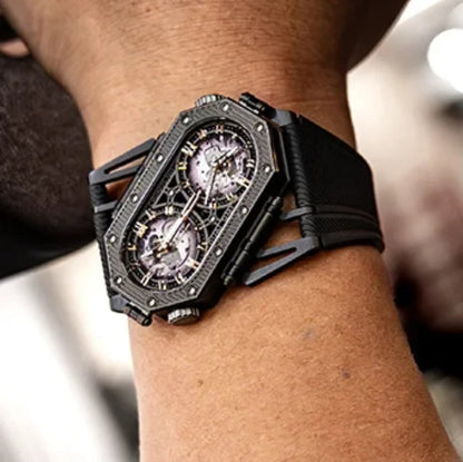 Black wristwatch on a person's arm with a blurred background