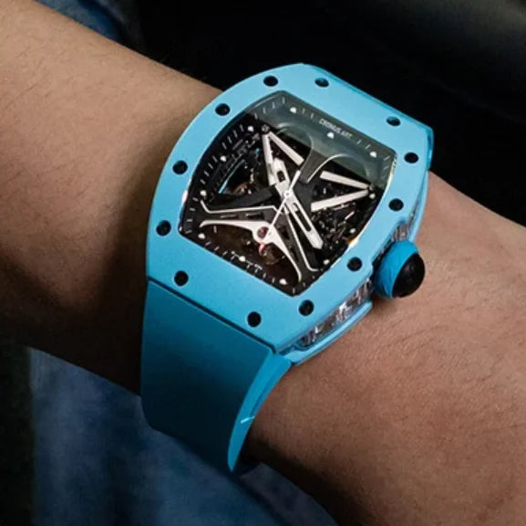 Blue wristwatch with a detailed face on a person's wrist