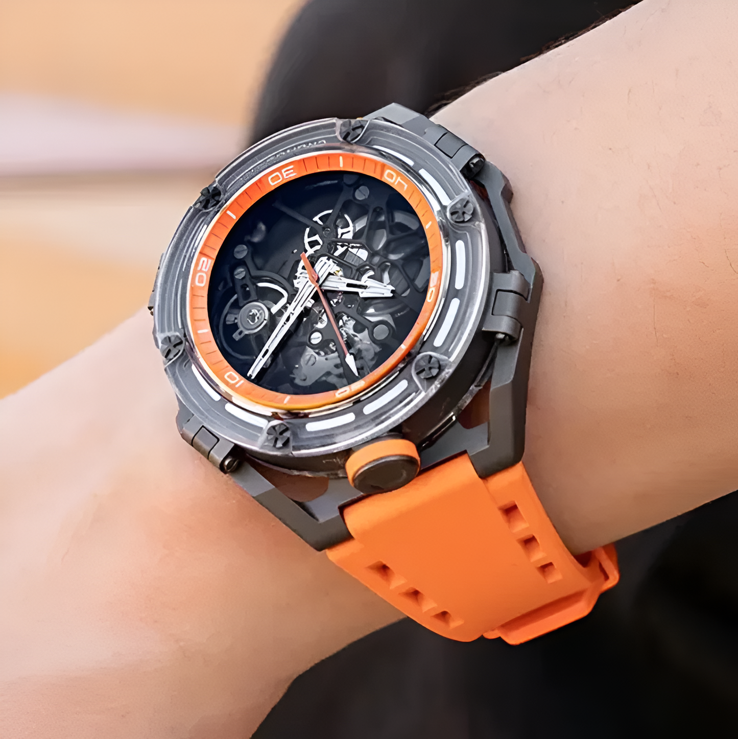 Men's wrist featuring the vibrant orange CRONUSART CM025 automatic watch.