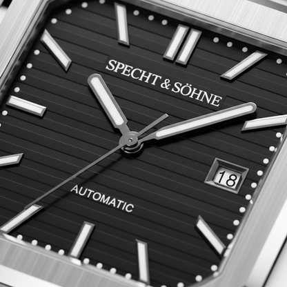 Close-up of a Specht & SÖhne watch with black face and silver accents.