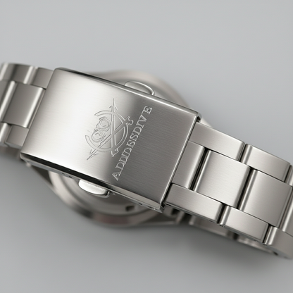 Close-up of a silver watch with brand engraving on a light gray background