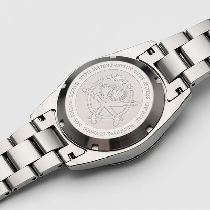 Close-up of a silver watch with engraved design on a light gray background