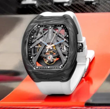 Luxury watch with a black face and white strap on a red surface