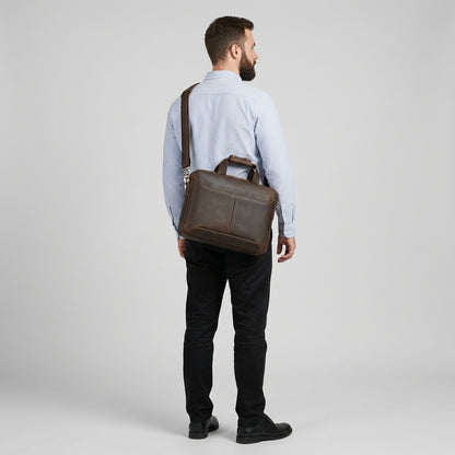 Men's Crazy Horse Leather Slim Laptop Briefcase — worn on the shoulder by a man in a light blue shirt, back view