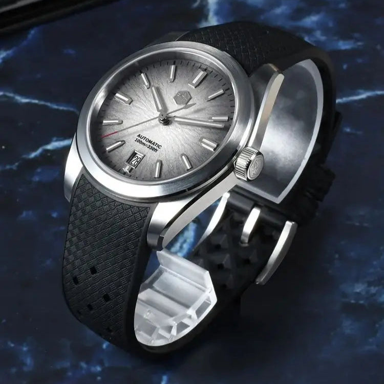 San Martin Horizon SN0144 automatic watch for men with frosted silver dial and textured black rubber strap on blue marble background.