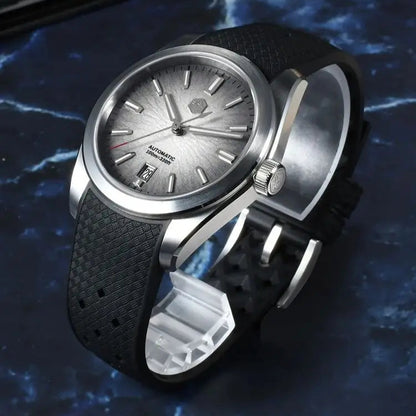 San Martin Horizon SN0144 automatic watch for men with frosted silver dial and textured black rubber strap on blue marble background.
