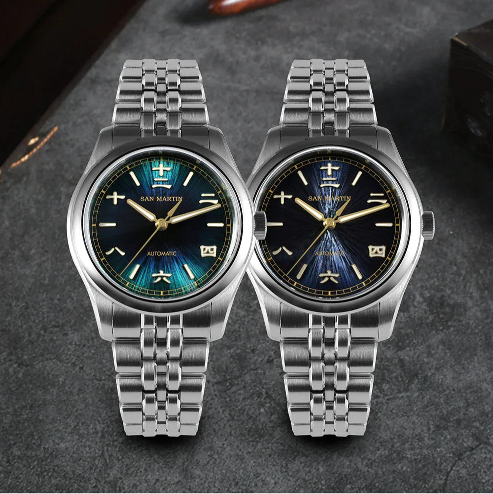 San Martin men’s automatic watches in grey blue and deep blue sunburst dials with steel bracelet.