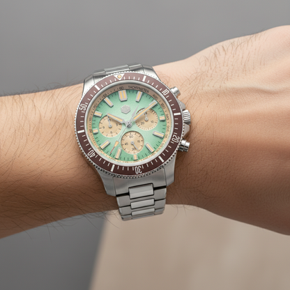 San Martin SL4801 chronograph diver watch worn on wrist featuring green bezel, pink dial, and stainless steel bracelet