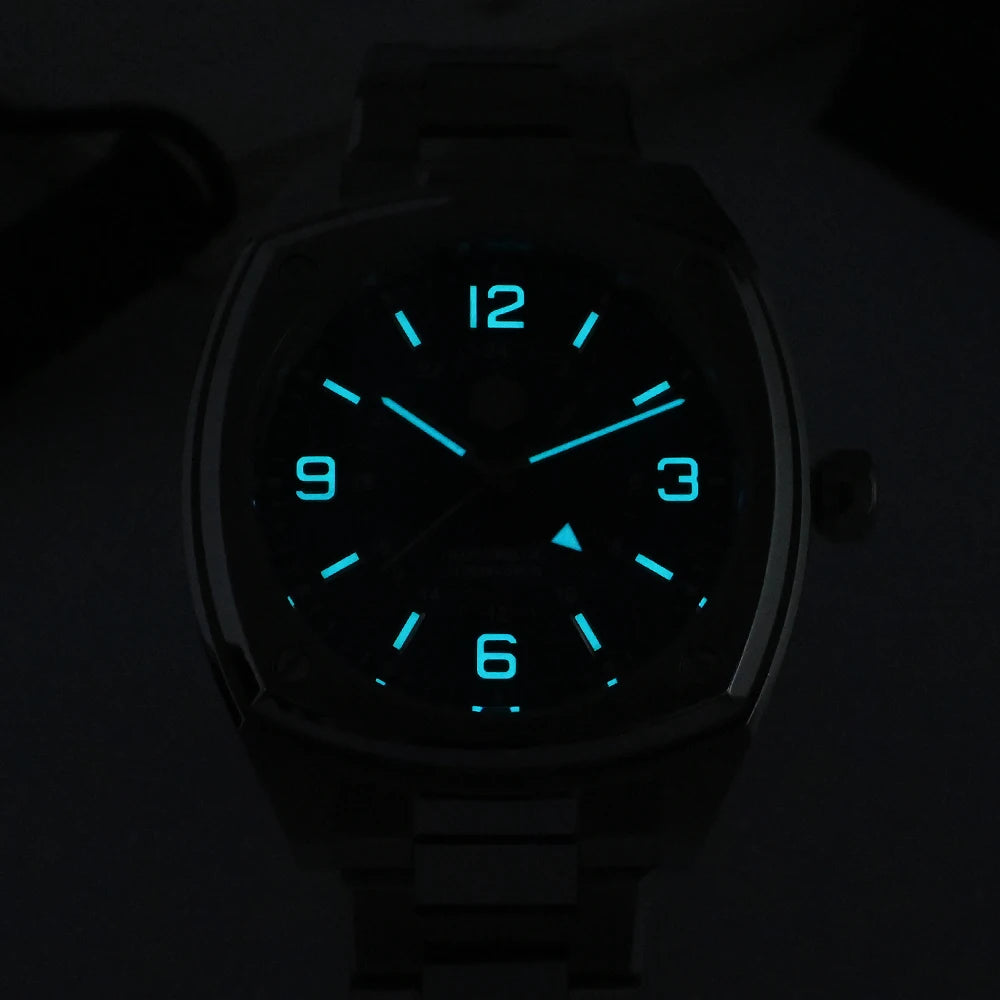 San Martin SN0026G Men’s Square GMT Automatic Watch in darkness showing blue luminous hour markers and hands glowing against the dial, emphasizing night visibility.