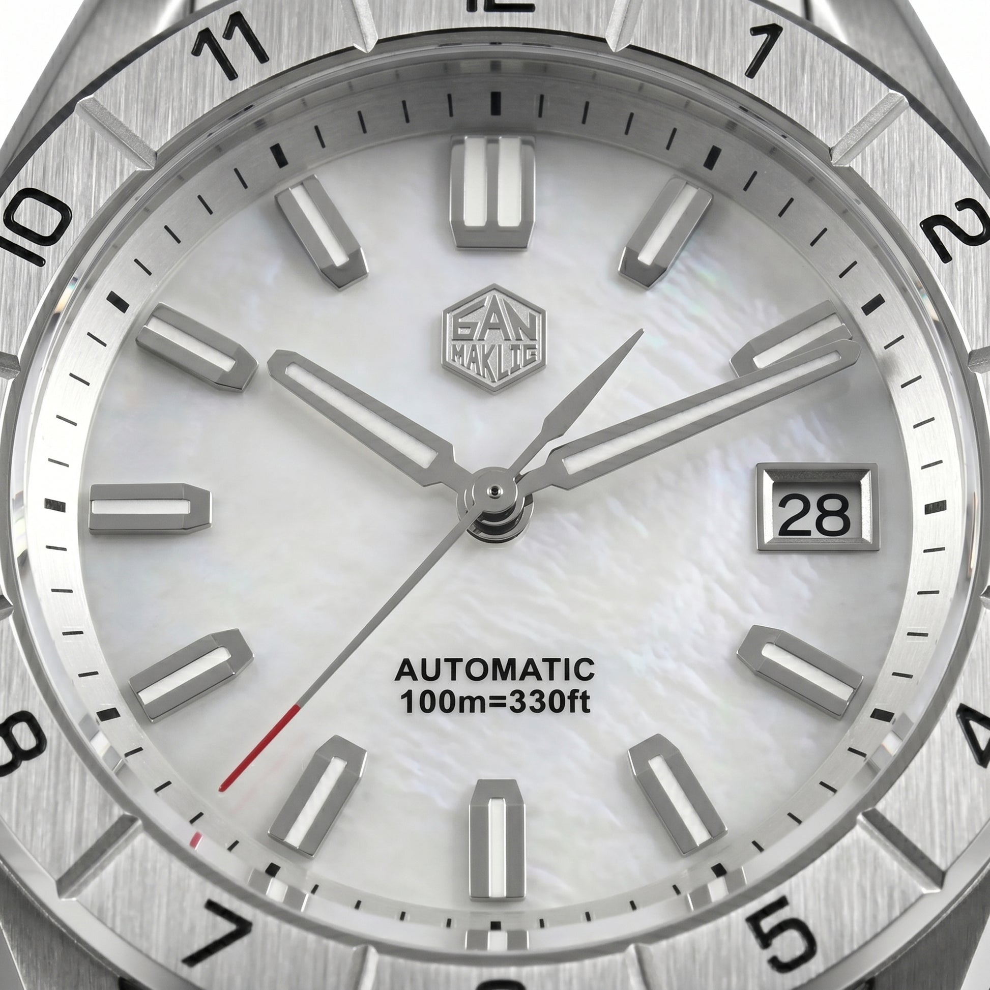San Martin SN0130GB - Close-up of a silver watch with a white face, brand logo, and text.
