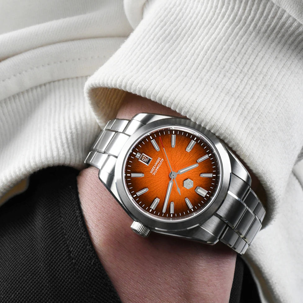 San Martin Horizon SN0144 men’s automatic watch with bright orange enamel dial and steel bracelet on wrist.