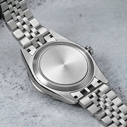 Silver watch with a metal bracelet on a gray surface