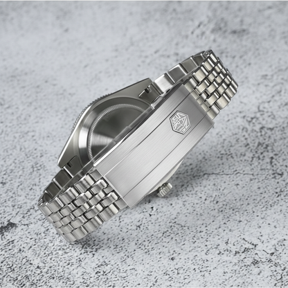 Silver watch with metal bracelet on a textured gray surface