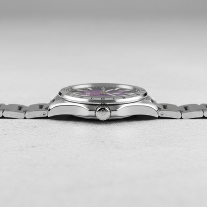 Silver watch with a purple face on a light gray background