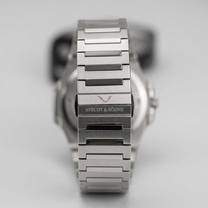 Silver watch with visible brand name on a light gray background