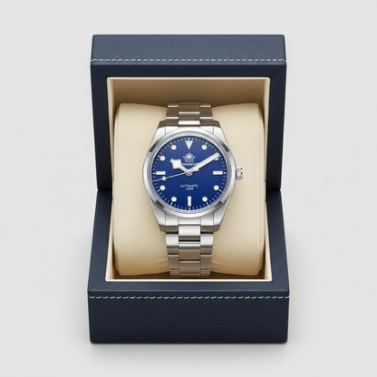 Watch with blue face and silver case in a blue box on a light gray background