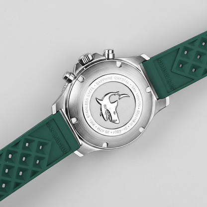 Watch with green strap and silver case on a light gray background