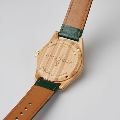 Wooden watch with green strap on a light gray background