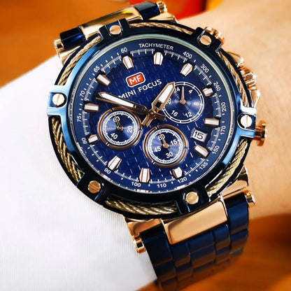 AURON blue and gold men’s quartz chronograph watch worn on a man’s wrist with a formal suit, showcasing its bold, refined luxury style