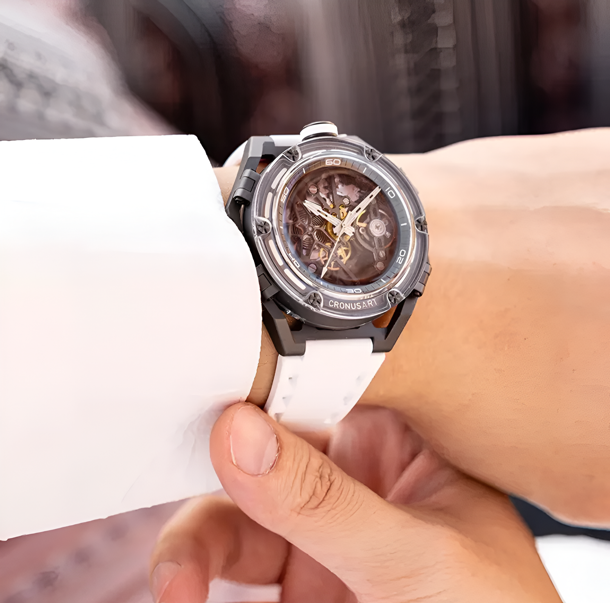 Man wearing CRONUSART CM025 white rubber strap skeleton watch on wrist.