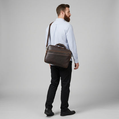 Men’s Leather Computer Briefcase — worn on the shoulder by a man in a light blue shirt, back view