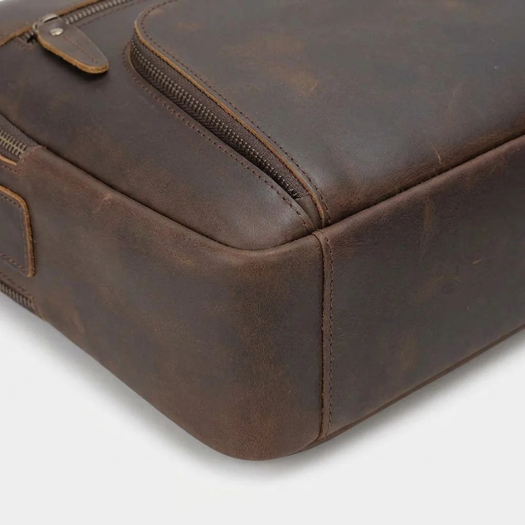 Men's Leather Laptop Briefcase with Dual Front Zip Pockets — close-up of zip pocket and base edge