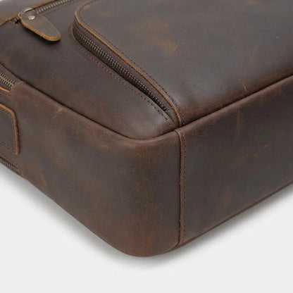 Men's Leather Laptop Briefcase with Dual Front Zip Pockets — close-up of zip pocket and base edge
