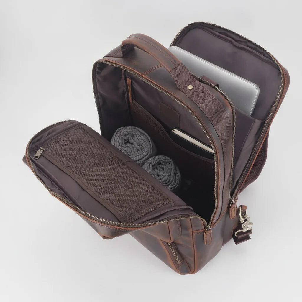 Vintage Leather Adventure Rucksack — open compartment with laptop, rolled clothes and notebook