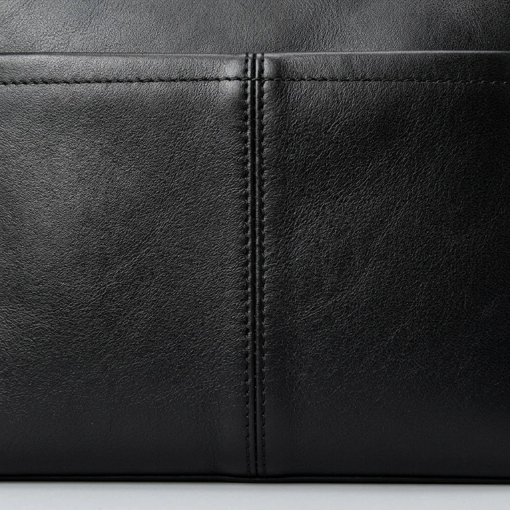 Men's Slim Black Leather Crossbody Bag — close-up of leather and pocket stitching