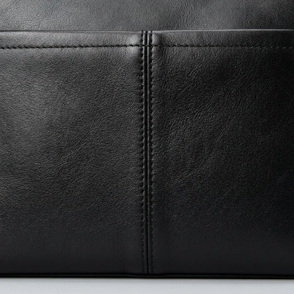 Men's Slim Black Leather Crossbody Bag — close-up of leather and pocket stitching