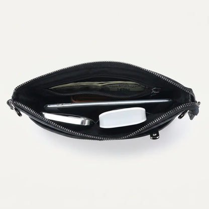 Men's Slim Black Leather Crossbody Bag — open top with phone, pen and earbuds case inside