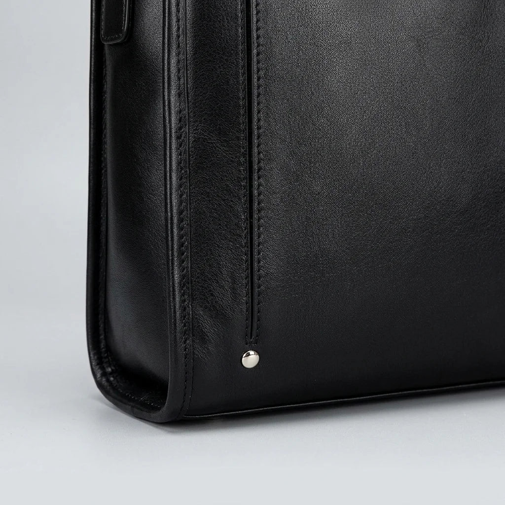 Men's Smooth Black Leather Laptop Briefcase — close-up of side seam and metal stud