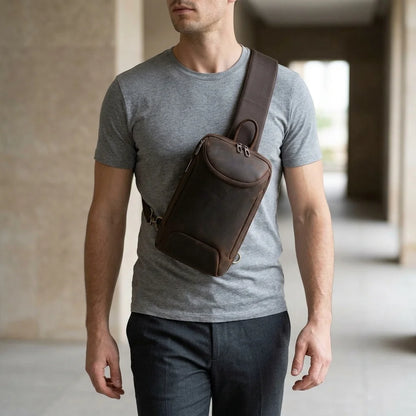 Men's Crazy Horse Leather Tablet Sling Bag — worn crossbody by a man in a grey T-shirt