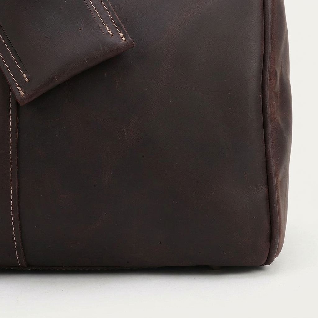 Men's Full-Grain Leather Barrel Duffle Bag — close-up of the leather corner and stitching
