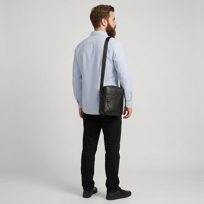 Men's Full-Grain Leather Compact Crossbody Messenger Bag — carried on the shoulder by a man in a striped shirt, rear three-quarter view