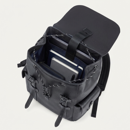 Men's Full-Grain Leather Flap Backpack with Drawstring Closure — open with a laptop, notebooks, a pouch and a pen inside