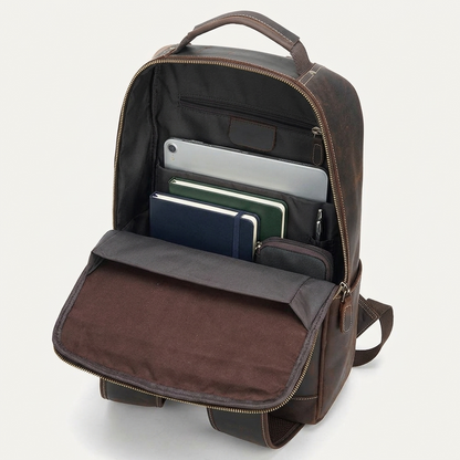 Men's Full-Grain Leather Slim Commuter Backpack — open with a laptop, notebooks, a pouch and a pen inside