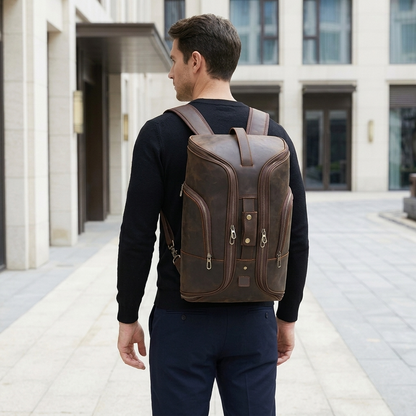 Men's Full-Grain Leather Travel Backpack with Hideaway Straps — worn on the back by a man in a black knit shirt, rear view