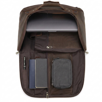 Men's Full-Grain Leather Travel Backpack with Hideaway Straps — open with a laptop, notebooks, a pouch and a pen inside