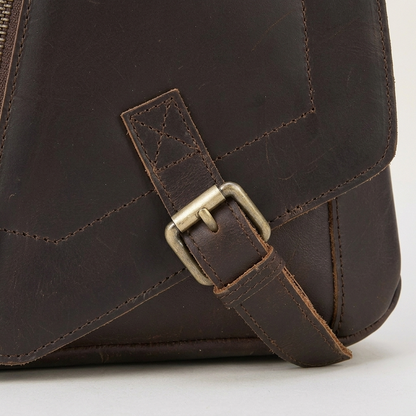 Men's Full-Grain Leather Triangle Sling Bag — close-up of the front pocket and stitching