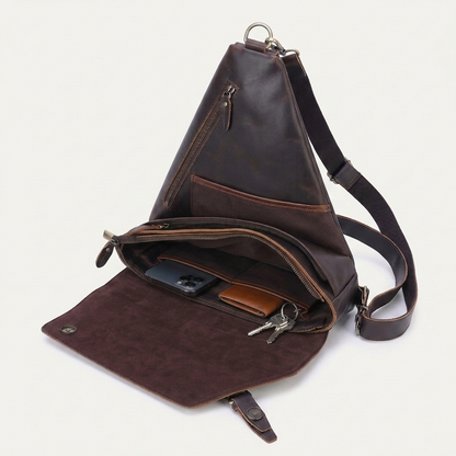 Men's Full-Grain Leather Triangle Sling Bag — open with a phone, card holder and keys inside