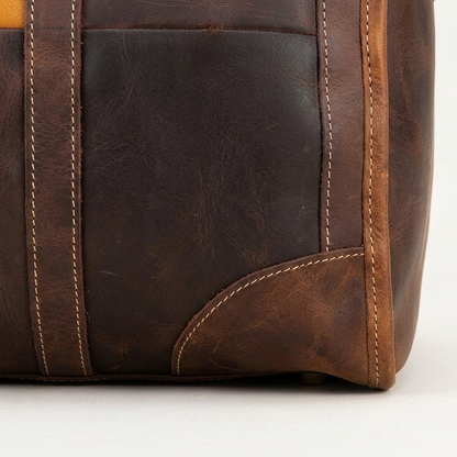 Men's Two-Tone Full-Grain Leather Duffle Bag — close-up of the leather corner and stitching