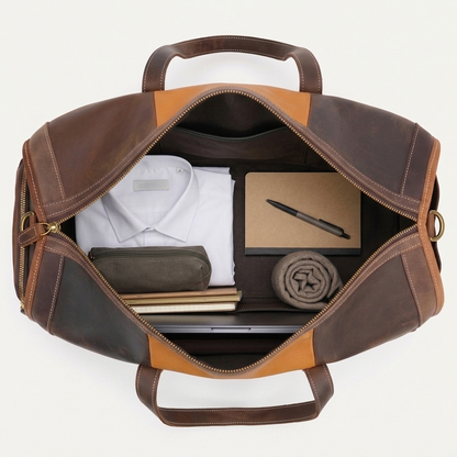 Men's Two-Tone Full-Grain Leather Duffle Bag — open from above with a shirt, notebooks and a laptop inside